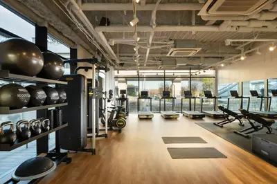 a gym with treadmills and elliptical machines at DoubleTree by Hilton Tokyo Ariake in Tokyo