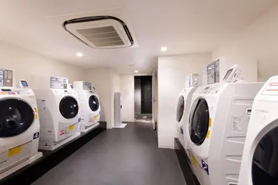 a laundry room with white washing machines on display at DoubleTree by Hilton Tokyo Ariake in Tokyo