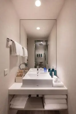 a bathroom with a sink and a large mirror at DoubleTree by Hilton Tokyo Ariake in Tokyo