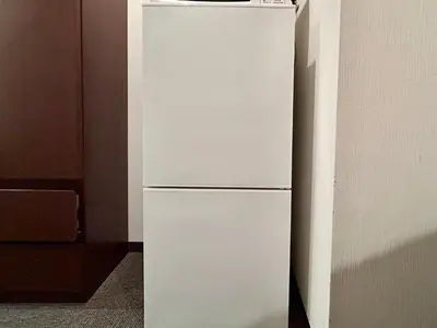 a white refrigerator freezer sitting in a room at Cypressinn Tokyo in Tokyo