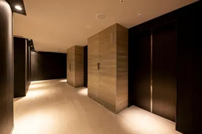 a row of elevators in a building with lights at remm Tokyo Kyobashi in Tokyo