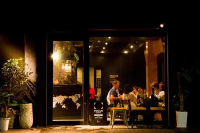 a group of people sitting at a table outside a restaurant at Focus Kuramae in Tokyo