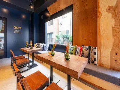 a room with tables and chairs and a couch at Focus Kuramae in Tokyo
