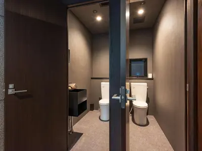 a small bathroom with two toilets and a television at Focus Kuramae in Tokyo