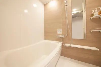 a bathroom with a white tub and a shower at S-peria Inn Nihombashi Hakozaki in Tokyo