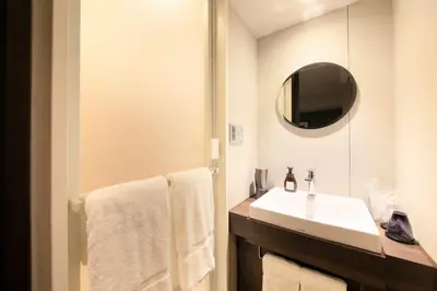 a bathroom with a white sink and a mirror at S-peria Inn Nihombashi Hakozaki in Tokyo