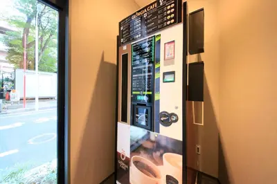 a vending machine on the side of a wall at S-peria Inn Nihombashi Hakozaki in Tokyo