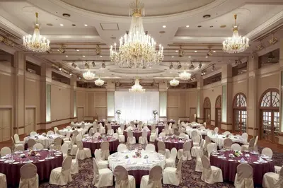 a banquet hall with tables and chairs and chandeliers at Dai-ichi Hotel Tokyo in Tokyo