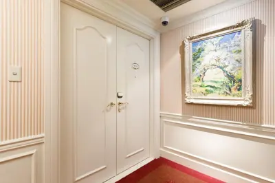 a hallway with a painting on the wall and a door at Dai-ichi Hotel Tokyo in Tokyo