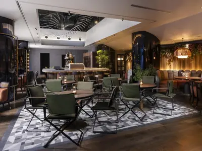 a restaurant with tables and chairs and a bar at Mercure Tokyo Hibiya in Tokyo