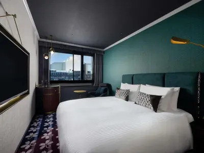 a bedroom with a large white bed and a window at Mercure Tokyo Hibiya in Tokyo