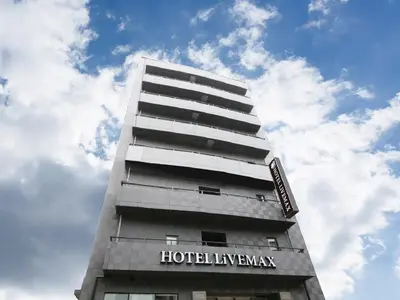 a tall building with a sign on it at HOTEL LiVEMAX Ueno-Ekimae in Tokyo