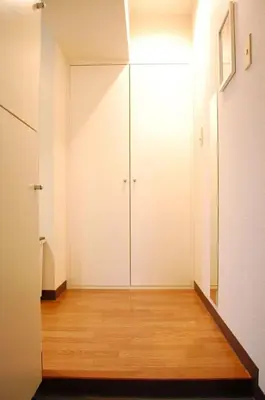 a hallway with white doors and a wooden floor at Urban Core Shikano 401 in Tokyo