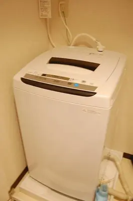 a white refrigerator in a room with a phone on it at Urban Core Shikano 401 in Tokyo