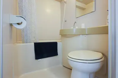 a bathroom with a white toilet and a blue towel at Urban Core Shikano 501 in Tokyo
