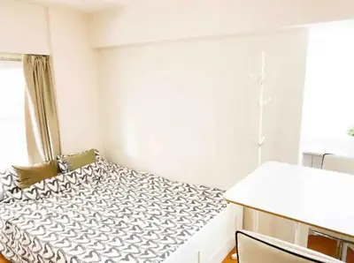 a small bedroom with a bed and a window at Urban Core Shikano 501 in Tokyo