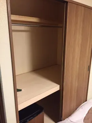 a cupboard in a bedroom with the door open at Ryokan Ichinao in Tokyo