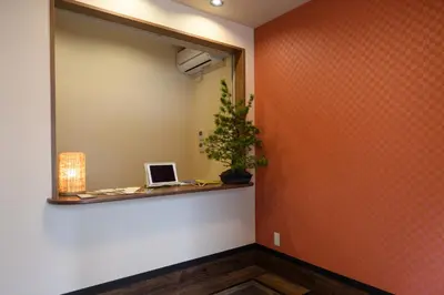 a hallway with a mirror and a laptop on a shelf at Ryokan Ichinao in Tokyo