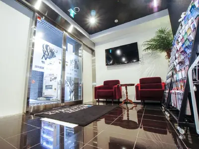 a waiting room with two red chairs and a table at HOTEL LiVEMAX Kasai Ekimae in Tokyo