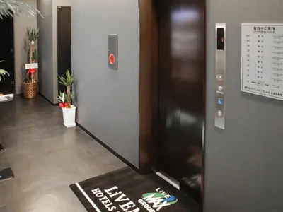 a elevator in an office with a sign on the floor at HOTEL LiVEMAX Tokyo Bakurocho in Tokyo