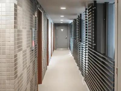 a hallway with brick walls and a long aisle at HOTEL LiVEMAX Tokyo Bakurocho in Tokyo