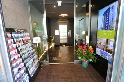 a aisle of a store with flowers in the door at HOTEL LiVEMAX Takadanobaba Ekimae in Tokyo