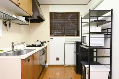 a small kitchen with a sink and a microwave at Evergreen hotel ichigaya luxe in Tokyo