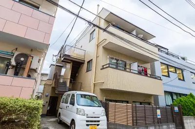 a white van parked in front of a building at Evergreen hotel ichigaya luxe in Tokyo