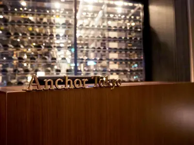 a sign on top of a counter with wine glasses at The Gate Hotel Tokyo by Hulic in Tokyo