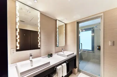 a bathroom with two sinks and a large mirror at The Gate Hotel Tokyo by Hulic in Tokyo