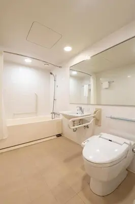 a bathroom with a toilet and a sink and a tub at Hotel Keihan Tokyo Yotsuya in Tokyo