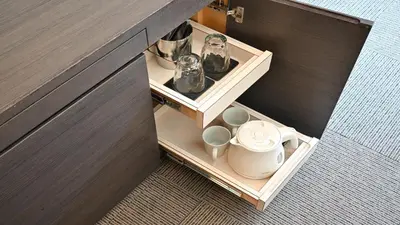 a drawer in a cabinet with cups and mugs at Hotel Keihan Tokyo Yotsuya in Tokyo