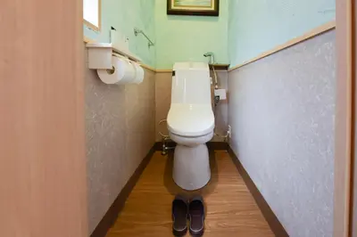 a bathroom with a toilet and a pair of shoes at Yoyogi House in Tokyo