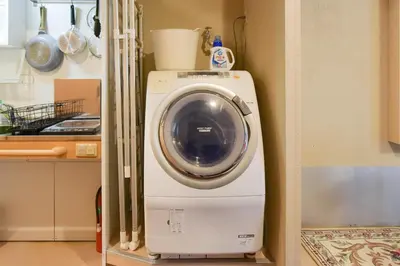 a washer and dryer is sitting in a kitchen at Yoyogi House in Tokyo