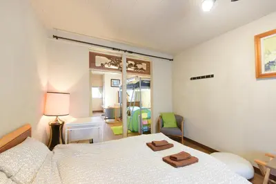 a bedroom with a bed with a pair of shoes on it at Yoyogi House in Tokyo