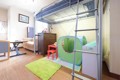 a room with a loft bed with a living room at Yoyogi House in Tokyo