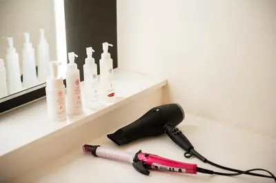 a blow dryer on a counter in a bathroom at First Cabin Ichigaya in Tokyo