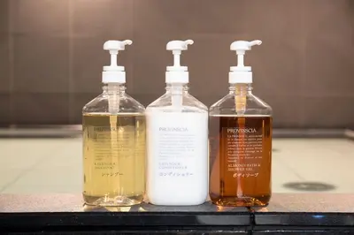 three bottles of alcohol are sitting on a counter at First Cabin Ichigaya in Tokyo
