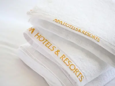 a stack of white towels with the words mattress inspections on them at APA Hotel Nihombashi Bakurocho Ekimae in Tokyo