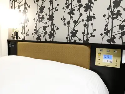 a bedroom with a bed with a clock on the wall at APA Hotel Nihombashi Bakurocho Ekimae in Tokyo