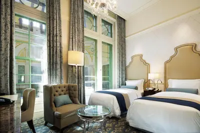 a hotel room with two beds and a chair at The Tokyo Station Hotel in Tokyo