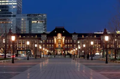 a large building with lights in a city at night at The Tokyo Station Hotel in Tokyo