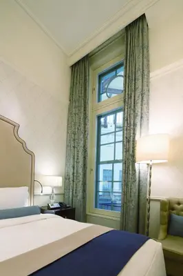 a hotel room with a bed and a window at The Tokyo Station Hotel in Tokyo