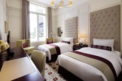 a hotel room with two beds and a chandelier at The Tokyo Station Hotel in Tokyo