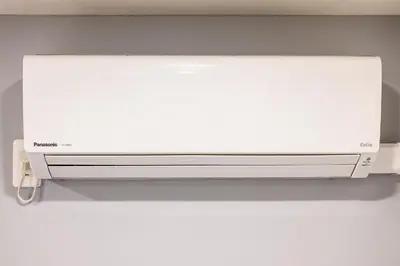 a white wall mounted air conditioner on a wall at Oku Apartment in Tokyo
