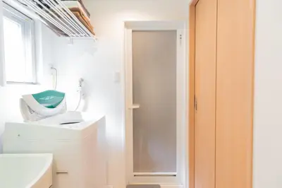a bathroom with a sink and a hair dryer at The Emilio 102 Shinjuku Near Shibuya in Tokyo