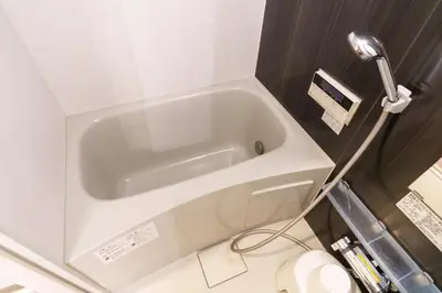 a white bath tub in a bathroom with a shower at The Emilio 102 Shinjuku Near Shibuya in Tokyo