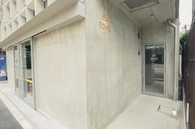 a facade of a building with a sign on it at DOMO Hotel in Tokyo