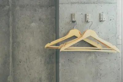 a couple of wooden hangers hanging on a wall at DOMO Hotel in Tokyo
