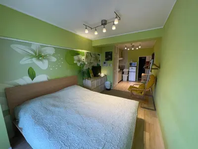 a bedroom with a bed with a flower on the wall at only 2 stops to shibuya sangenjaya apt in Tokyo